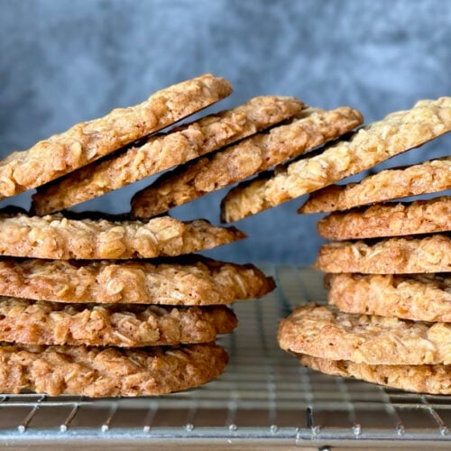 Crunchy oat biscuits in a stack on a cooling rack.
